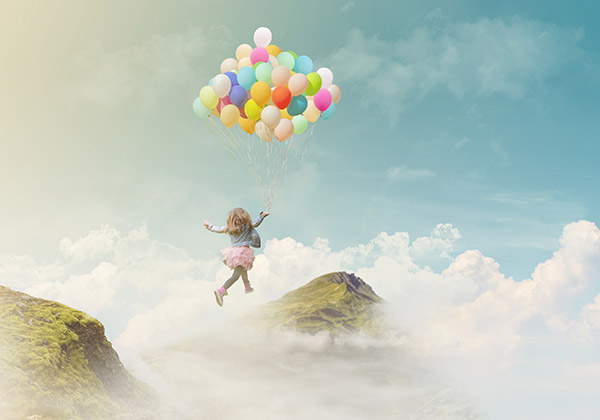 Little girl flying away with a bunch of balloons